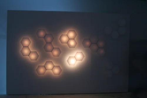 The rice-paper wall, lit and responding to motion.