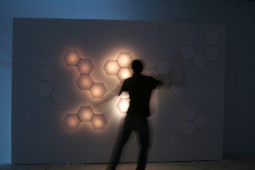 The rice-paper wall, lit and responding to motion.