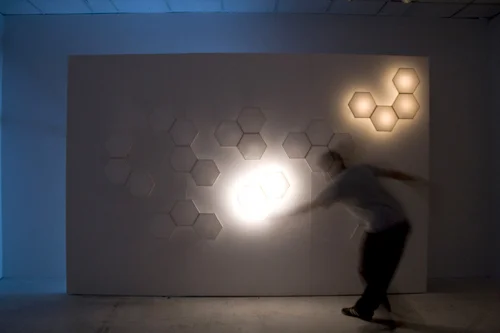 The rice-paper wall, lit and responding to motion.